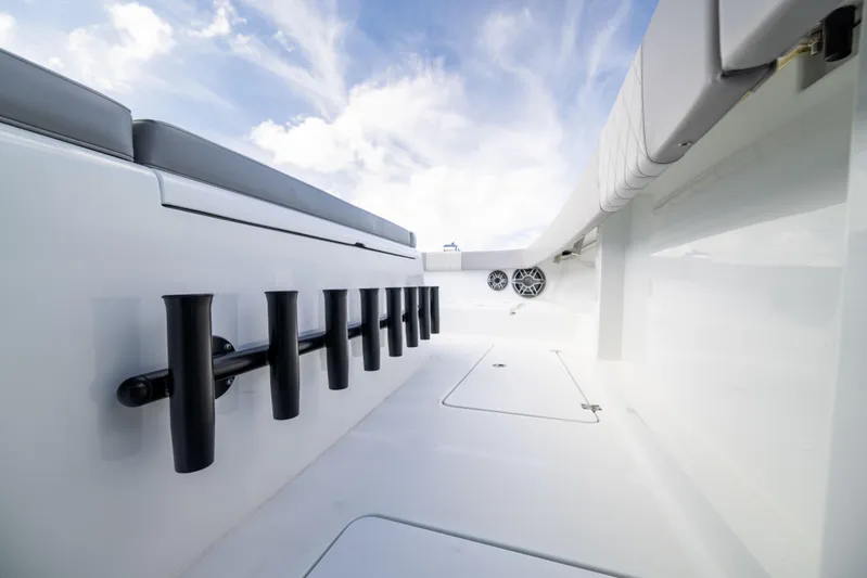  Yacht Photos Pics 2024 Freeman 42 LR boat interior with rod holders and seating under a blue sky.