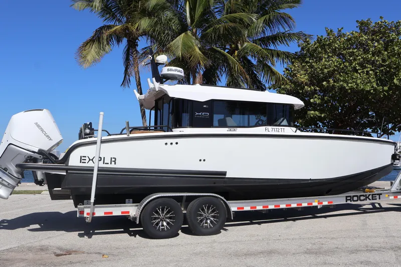  Yacht Photos Pics 2024 XO Boats EXPLR 10 S Plus on trailer, palm trees in background.