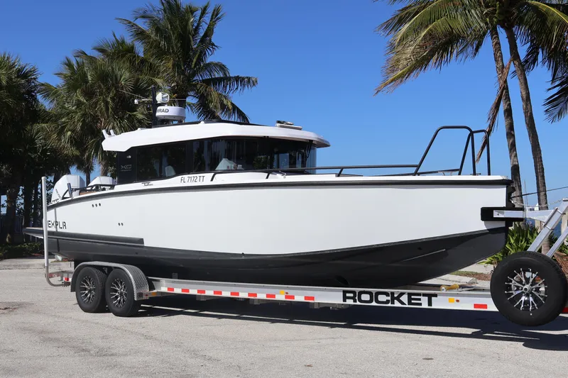  Yacht Photos Pics 2024 XO Boats EXPLR 10 S Plus on trailer, parked near palm trees.