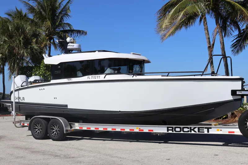  Yacht Photos Pics 2024 XO Boats EXPLR 10 S Plus on trailer, palm trees in background.