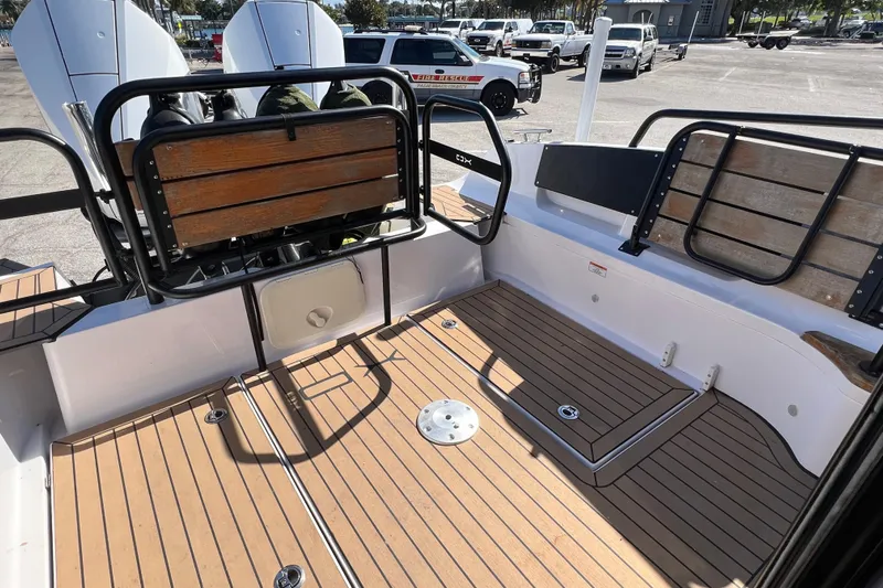  Yacht Photos Pics 2024 XO Boats EXPLR 10 S Plus deck with wooden seating and modern design.