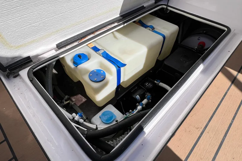  Yacht Photos Pics 2024 XO Boats EXPLR 10 S Plus storage compartment with water tanks and hoses.