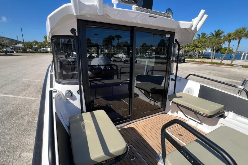  Yacht Photos Pics 2024 XO Boats EXPLR 10 S Plus, docked with seating and glass doors, sunny day.