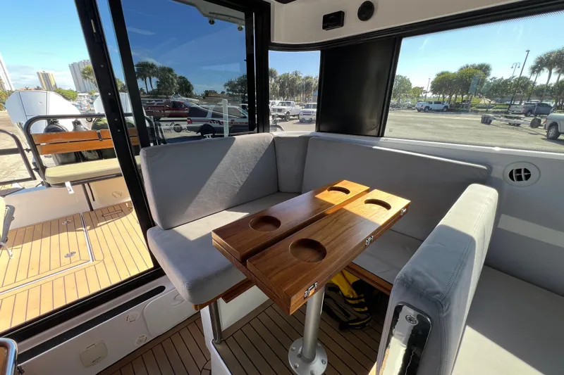  Yacht Photos Pics Interior of 2024 XO Boats EXPLR 10 S Plus with seating and wooden table.