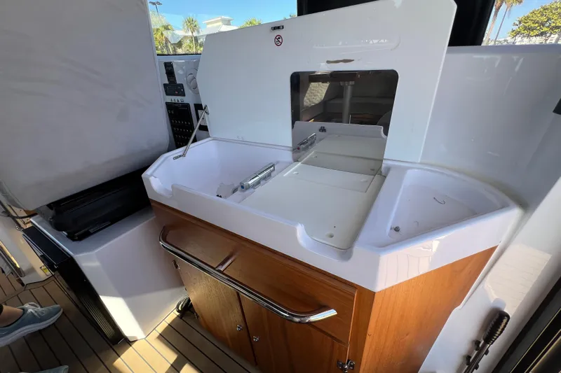  Yacht Photos Pics 2024 XO Boats EXPLR 10 S Plus interior with sink and storage cabinet.