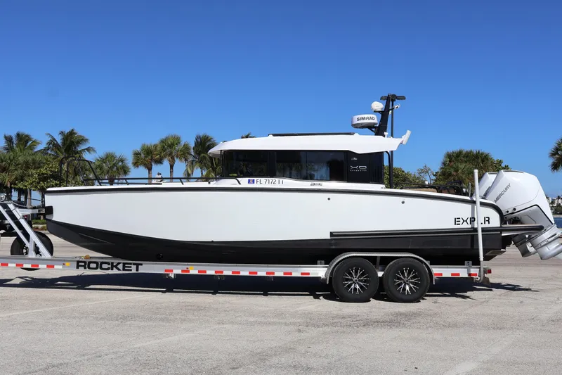  Yacht Photos Pics 2024 XO Boats EXPLR 10 S Plus on trailer, parked with palm trees in background.