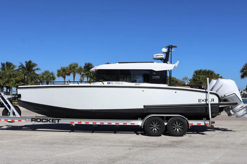  Yacht Photos Pics 2024 XO Boats EXPLR 10 S Plus on trailer, parked with palm trees in background.