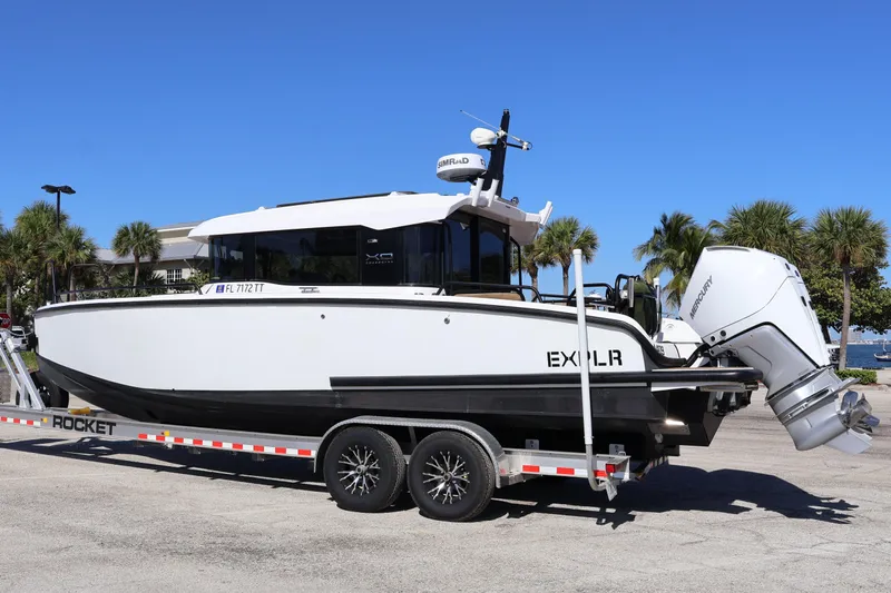  Yacht Photos Pics 2024 XO Boats EXPLR 10 S Plus on trailer, parked outdoors under clear blue sky.