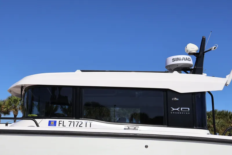  Yacht Photos Pics 2024 XO Boats EXPLR 10 S Plus with Simrad radar, side view against blue sky.