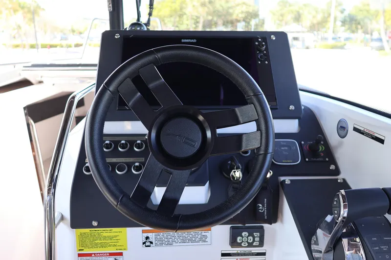 Yacht Photos Pics 2024 XO Boats EXPLR 10 S Plus helm with steering wheel and control panel.
