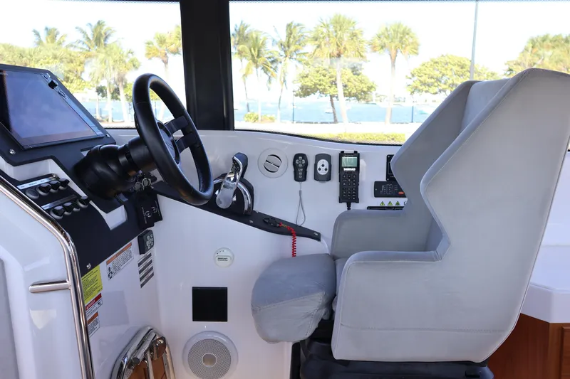  Yacht Photos Pics 2024 XO Boats EXPLR 10 S Plus helm with steering wheel and control panel.