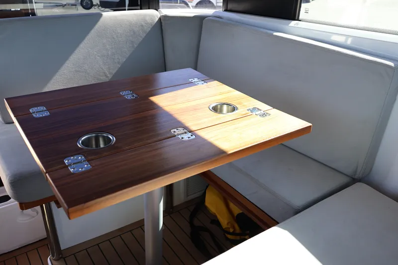  Yacht Photos Pics Interior seating area of 2024 XO Boats EXPLR 10 S Plus with wooden table.