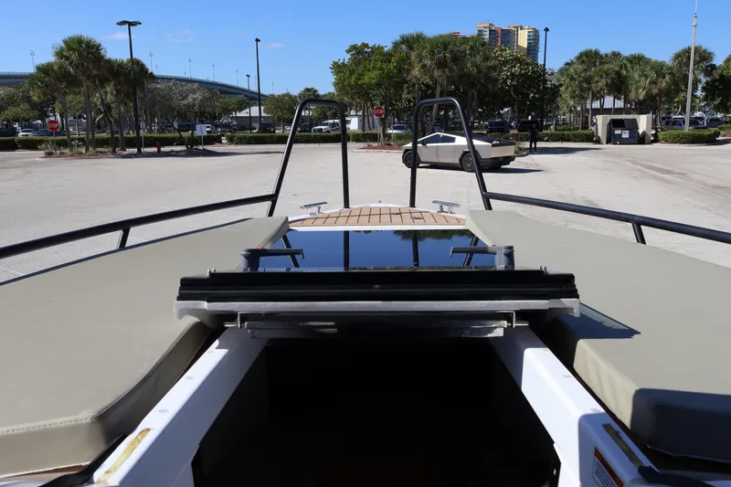  Yacht Photos Pics 2024 XO Boats EXPLR 10 S Plus, docked with open hatch, in sunny parking area.