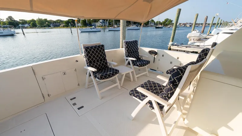  Yacht Photos Pics 1996 Tollycraft 57 Pilothouse Motor Yacht deck with cushioned chairs overlooking marina.