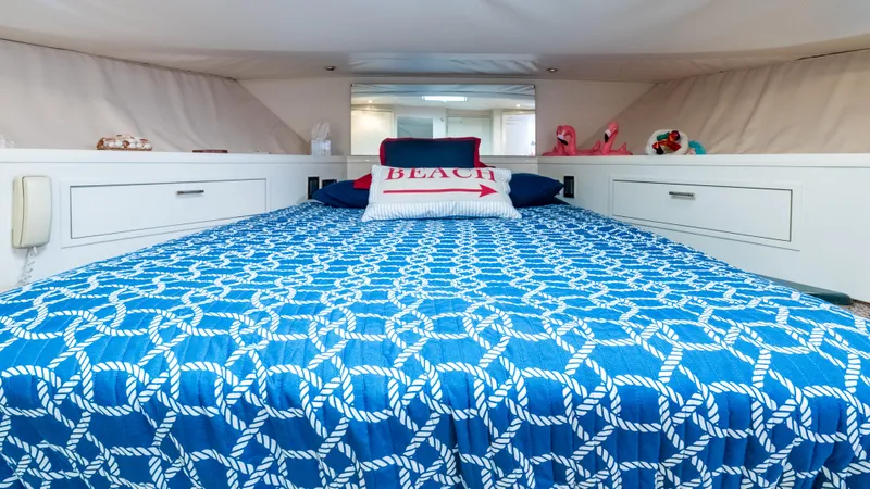  Yacht Photos Pics Luxurious bedroom in 1996 Tollycraft 57 Pilothouse Motor Yacht with nautical-themed bedding.