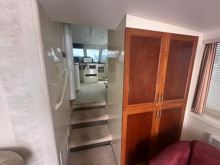  Yacht Photos Pics Interior of 1996 Tollycraft 57 Pilothouse Motor Yacht with steps and wooden cabinetry.