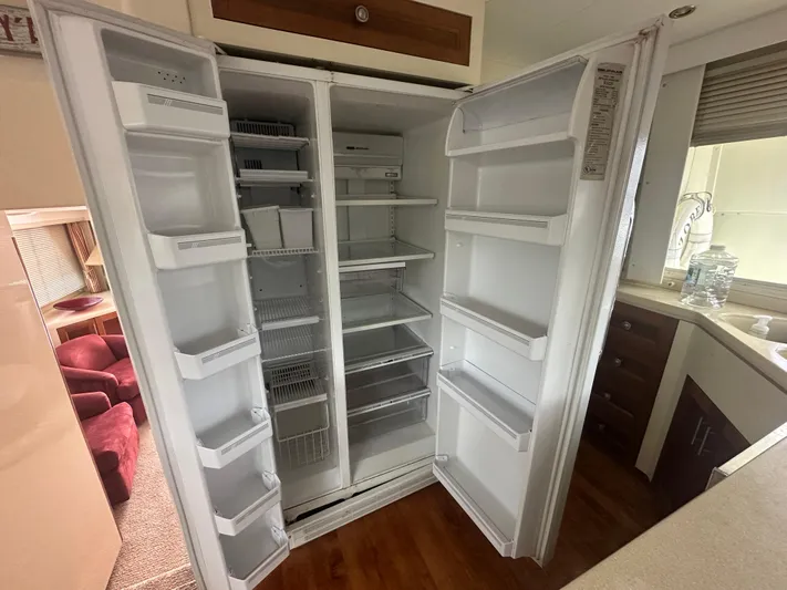  Yacht Photos Pics Open refrigerator in 1996 Tollycraft 57 Pilothouse Motor Yacht kitchen, showing empty shelves.