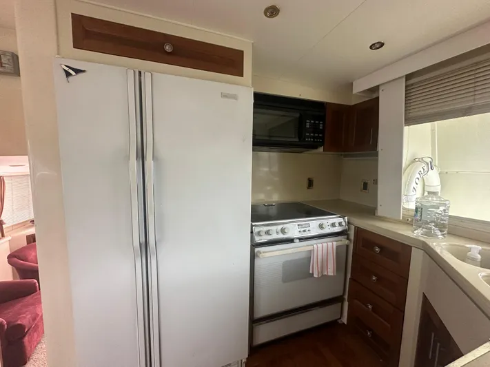  Yacht Photos Pics 1996 Tollycraft 57 Pilothouse Motor Yacht kitchen with fridge, stove, and microwave.