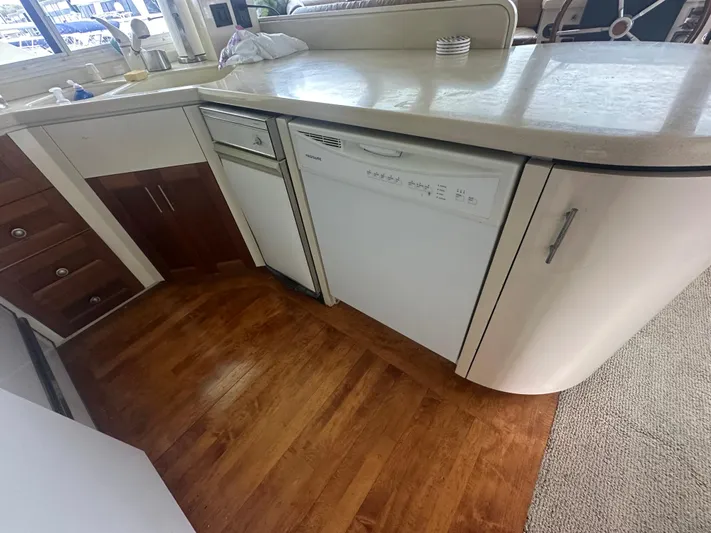  Yacht Photos Pics Kitchen area of 1996 Tollycraft 57 Pilothouse Motor Yacht with dishwasher and wooden flooring.