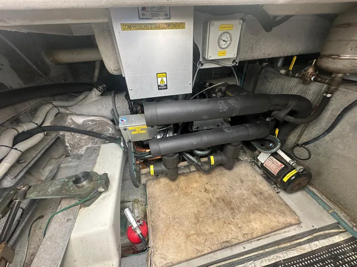  Yacht Photos Pics Engine room of 1996 Tollycraft 57 Pilothouse Motor Yacht with compressor components.