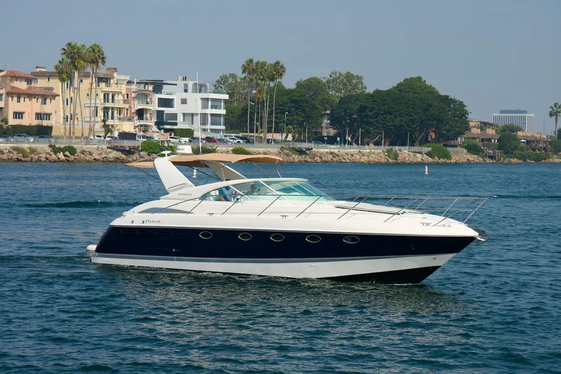 Back Up Plan Yacht Photos Pics 2001 Fairline 43 yacht cruising on a sunny day near coastal buildings.