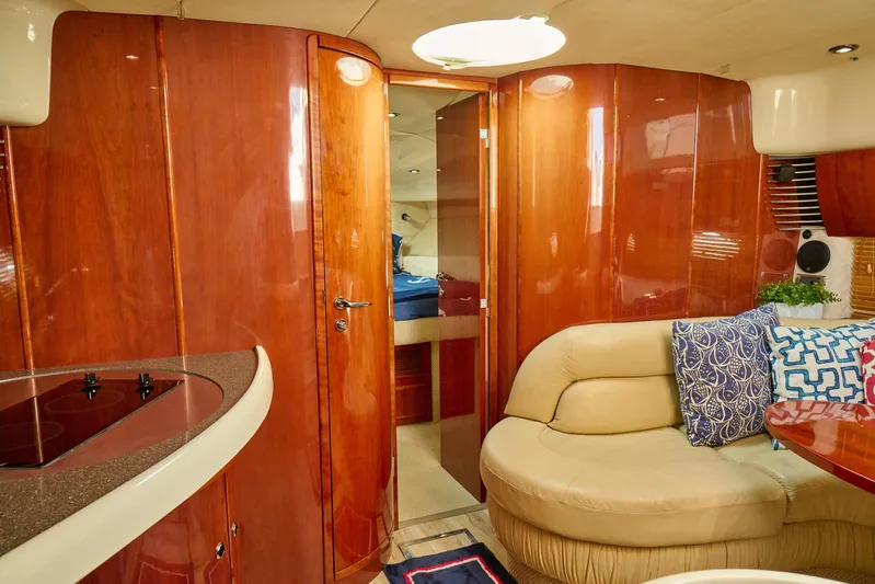 Back Up Plan Yacht Photos Pics Luxurious interior of a 2001 Fairline 43 yacht with wood paneling and plush seating.