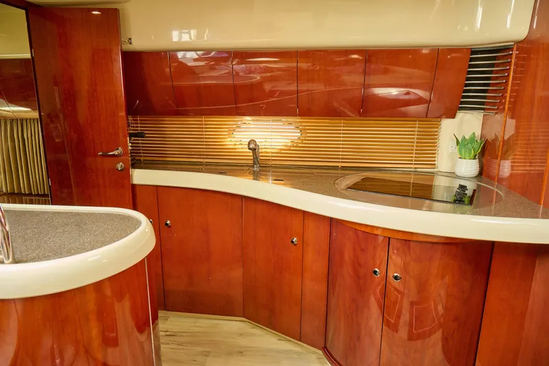 Back Up Plan Yacht Photos Pics Luxurious 2001 Fairline 43 yacht kitchen with sleek wood cabinetry and modern fixtures.