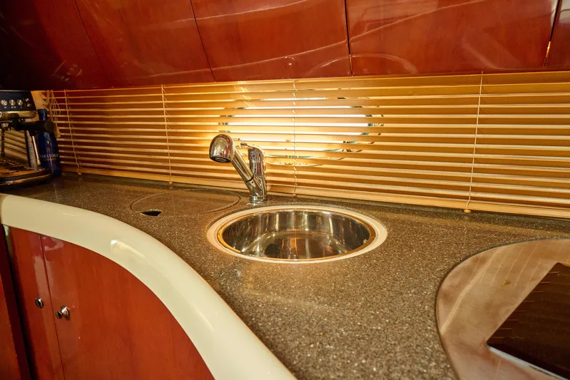 Back Up Plan Yacht Photos Pics Luxurious kitchen sink area on a 2001 Fairline 43 yacht with wooden cabinetry.
