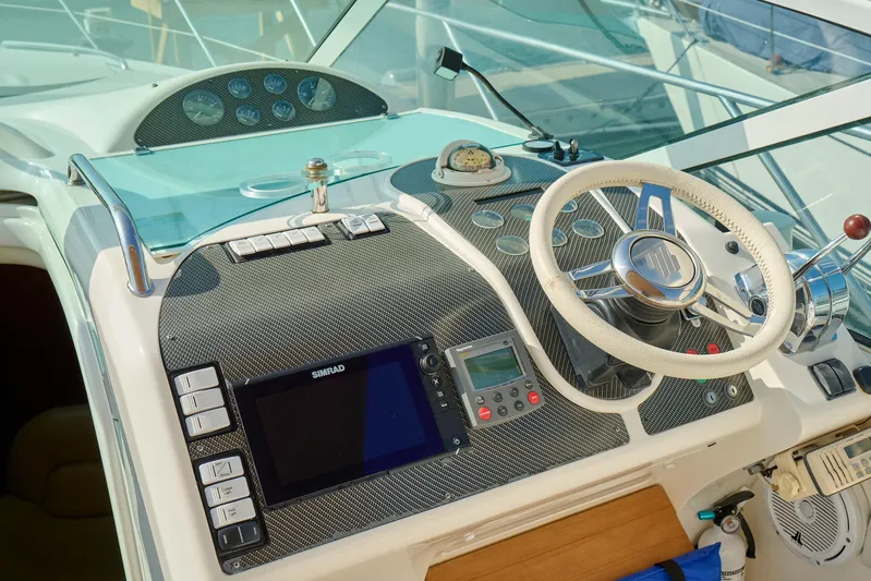 Back Up Plan Yacht Photos Pics Cockpit of 2001 Fairline 43 yacht with steering wheel and navigation controls.