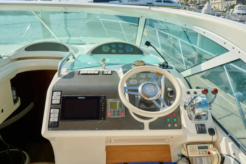 Back Up Plan Yacht Photos Pics Cockpit of 2001 Fairline 43 yacht with steering wheel and navigation controls.