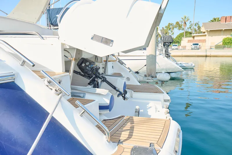 Back Up Plan Yacht Photos Pics Fairline 43 yacht from 2001 docked, showcasing open engine compartment and wooden deck.