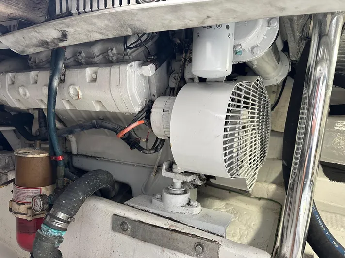  Yacht Photos Pics Engine compartment of a 2000 Cabo Convertible boat, showcasing mechanical components and wiring.