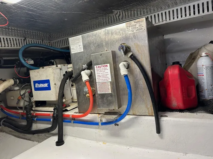  Yacht Photos Pics Engine room of 2000 Cabo Convertible with cooling system and fuel containers.