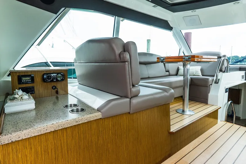  Yacht Photos Pics Luxurious interior of 2013 Cruisers Yachts 48 Cantius with plush seating and elegant table.