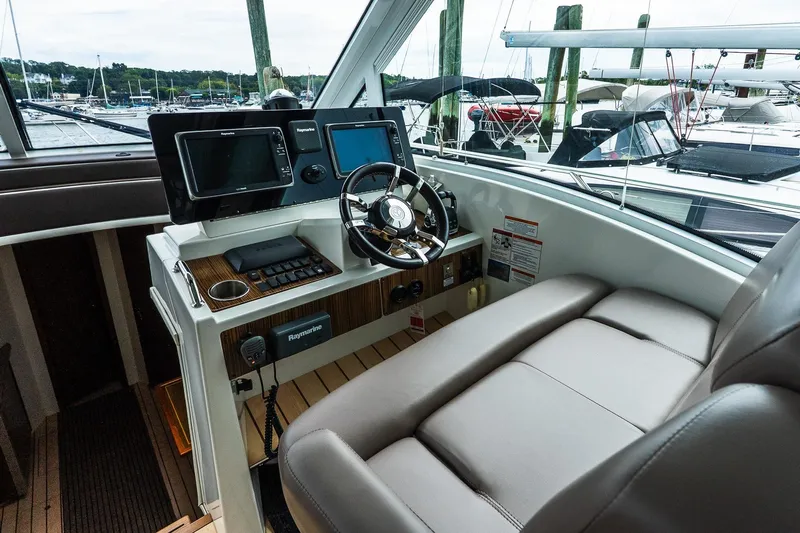  Yacht Photos Pics Helm of 2013 Cruisers Yachts 48 Cantius with modern navigation equipment and comfortable seating.