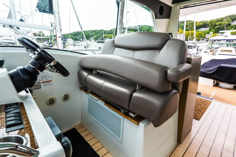  Yacht Photos Pics Luxurious helm seat on 2013 Cruisers Yachts 48 Cantius, featuring sleek design and comfort.