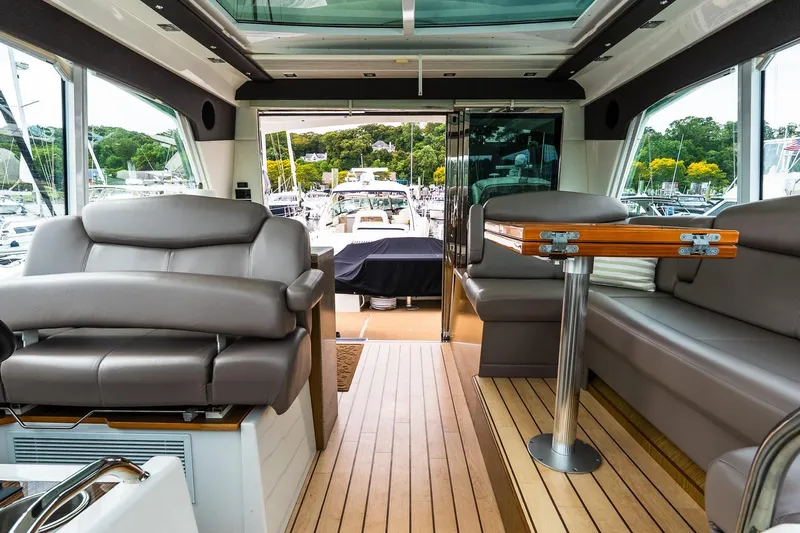  Yacht Photos Pics Luxurious interior of 2013 Cruisers Yachts 48 Cantius with leather seating and wooden flooring.