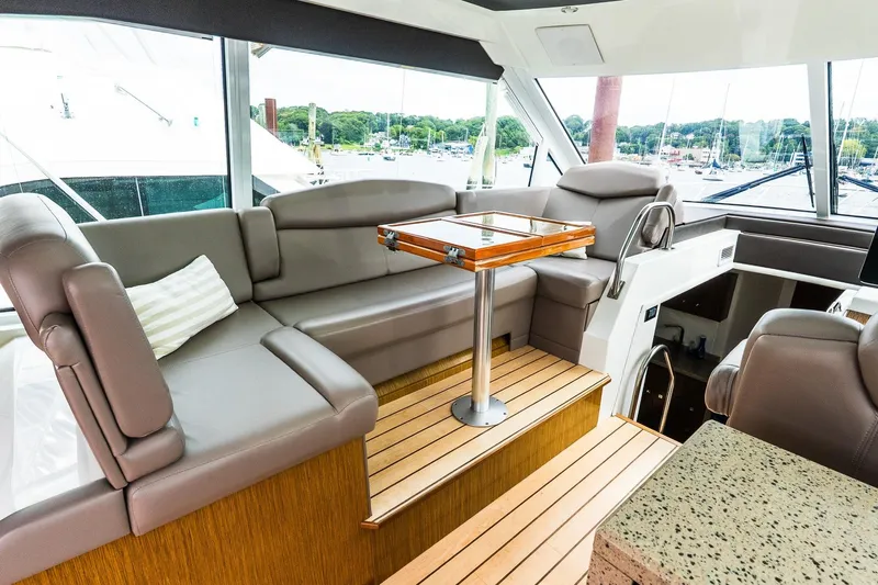  Yacht Photos Pics Luxurious interior of 2013 Cruisers Yachts 48 Cantius with plush seating and elegant table.