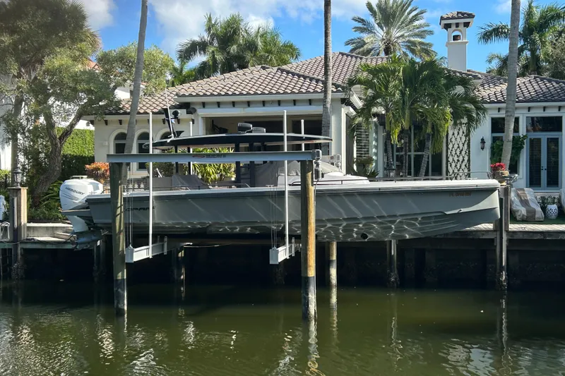  Yacht Photos Pics 2018 Axopar 37 SUN TOP BRABUS boat docked by a luxurious waterfront home.