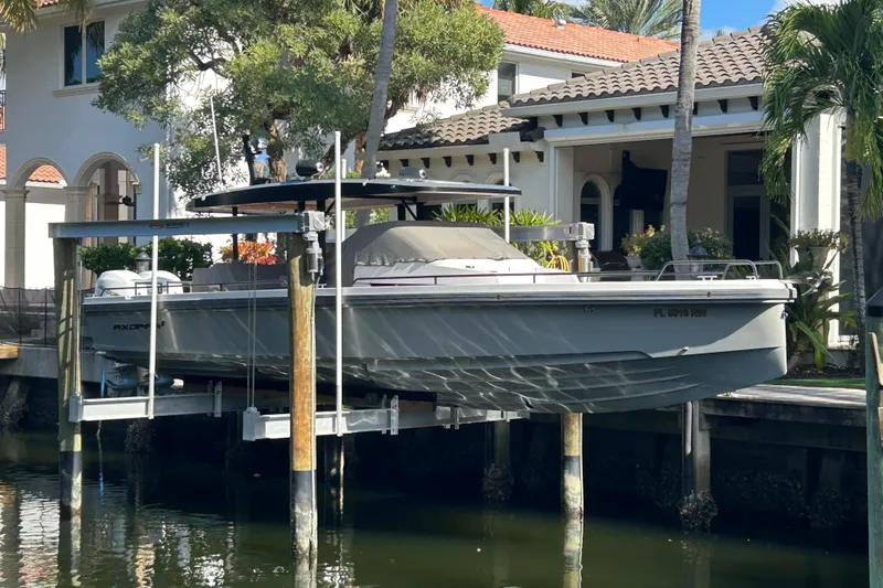  Yacht Photos Pics 2018 Axopar 37 SUN TOP BRABUS boat docked near a luxurious waterfront home.