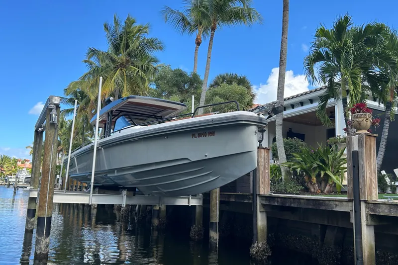  Yacht Photos Pics 2018 Axopar 37 SUN TOP BRABUS boat docked near tropical waterfront home.