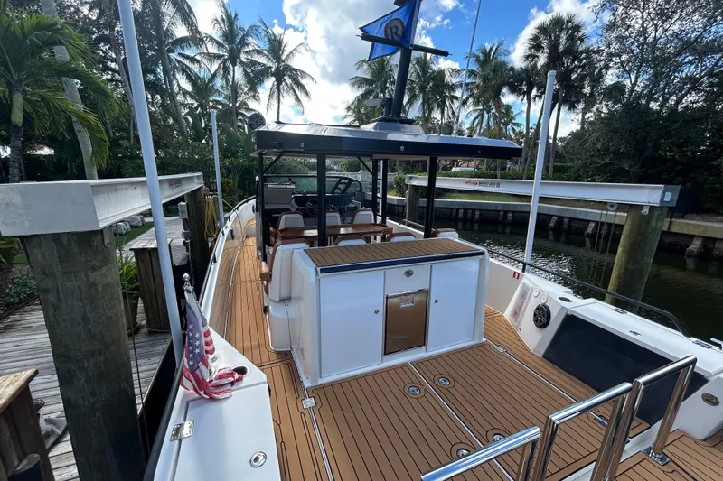  Yacht Photos Pics 2018 Axopar 37 SUN TOP BRABUS boat docked, surrounded by palm trees and clear skies.