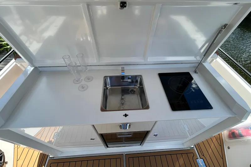  Yacht Photos Pics Outdoor kitchenette on 2018 Axopar 37 SUN TOP BRABUS with sink and cooktop.