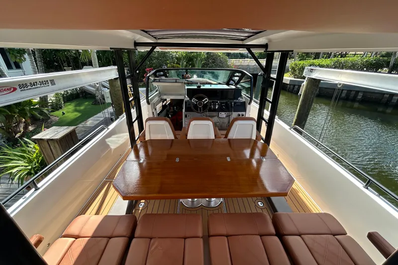  Yacht Photos Pics 2018 Axopar 37 SUN TOP BRABUS boat interior with seating and steering console.