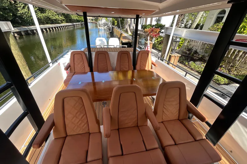  Yacht Photos Pics Luxurious interior of 2018 Axopar 37 SUN TOP BRABUS with leather seating and wooden table.