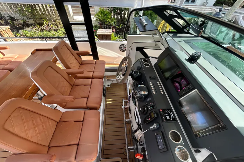  Yacht Photos Pics Luxurious interior of 2018 Axopar 37 SUN TOP BRABUS with leather seating and advanced controls.
