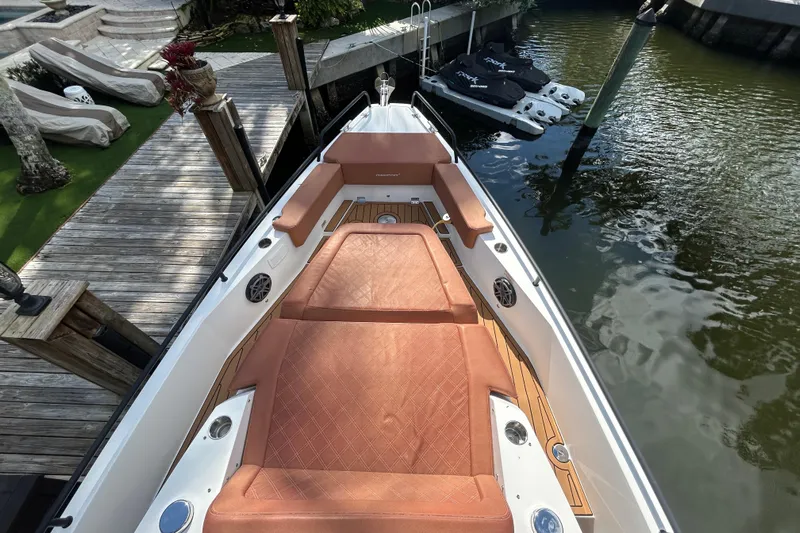  Yacht Photos Pics 2018 Axopar 37 SUN TOP BRABUS boat with luxurious seating, docked by the water.