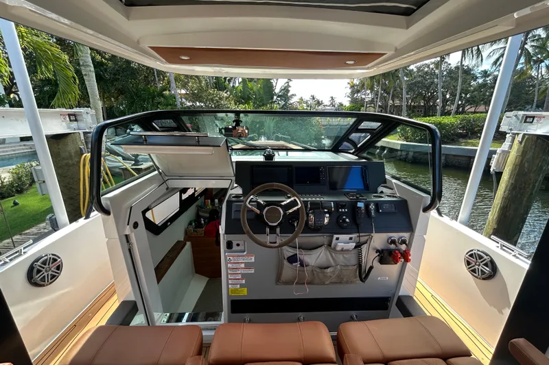  Yacht Photos Pics Interior view of 2018 Axopar 37 SUN TOP BRABUS boat cockpit with modern controls.