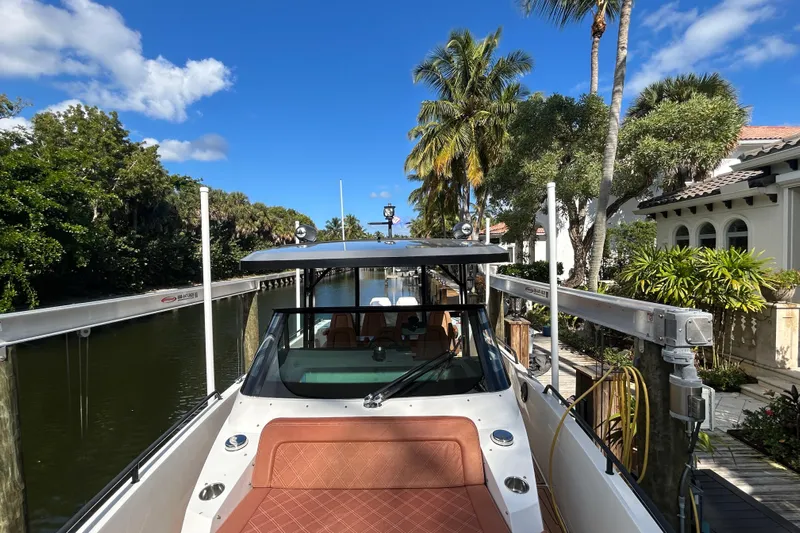  Yacht Photos Pics 2018 Axopar 37 SUN TOP BRABUS docked by a lush, tropical canal.