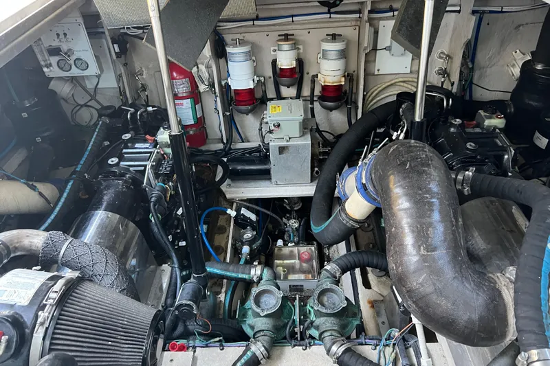  Yacht Photos Pics Engine room of a 2010 Sea Ray 450 Sundancer with visible components and fire extinguisher.